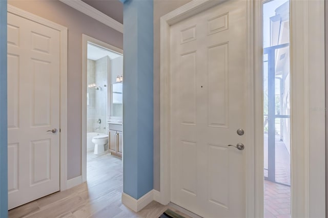 foyer with light wood finished floors and baseboards