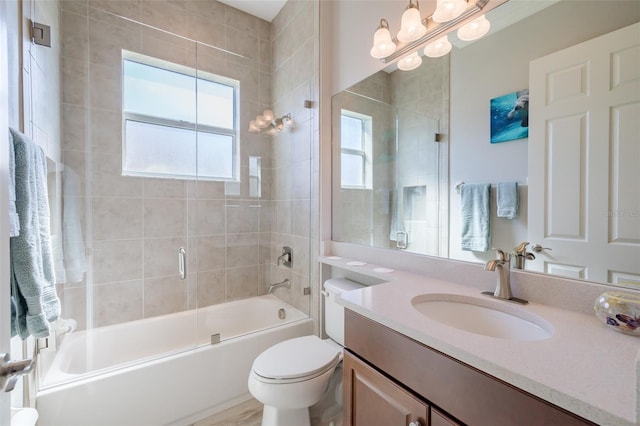 full bath featuring enclosed tub / shower combo, toilet, and vanity