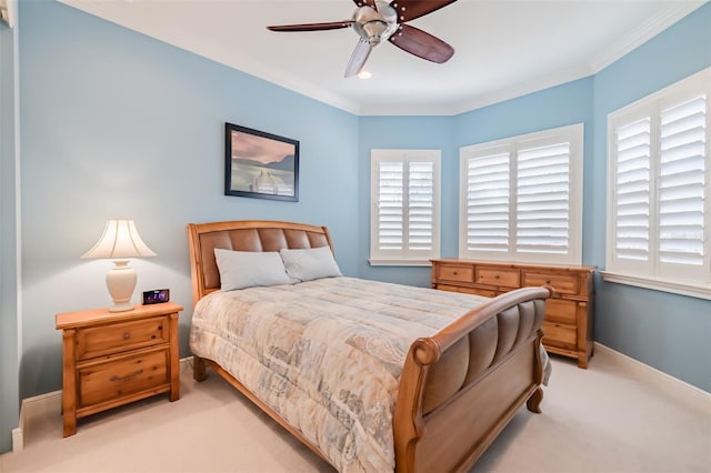 bedroom featuring light carpet, ceiling fan, baseboards, and ornamental molding