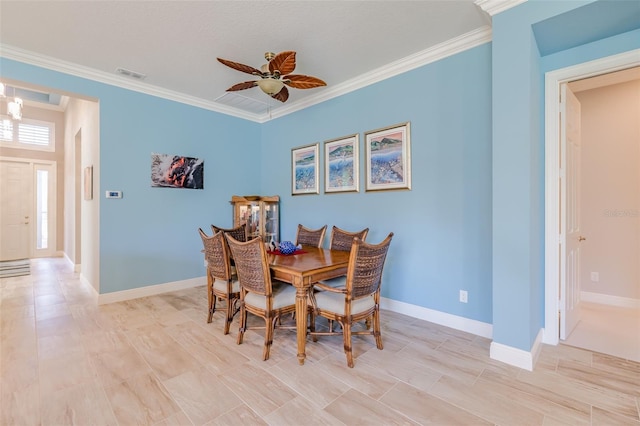 dining area featuring ornamental molding, visible vents, and baseboards