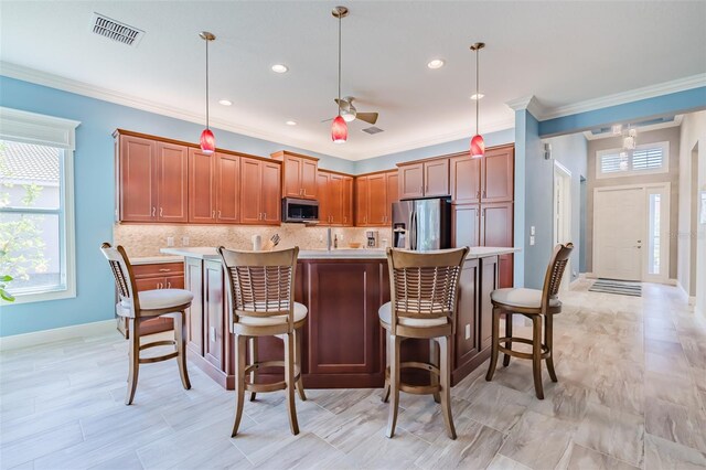 kitchen featuring light countertops, appliances with stainless steel finishes, backsplash, and visible vents