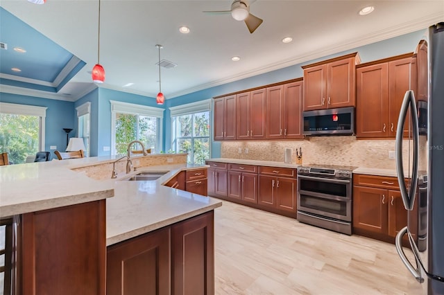 kitchen with crown molding, visible vents, decorative backsplash, appliances with stainless steel finishes, and a sink