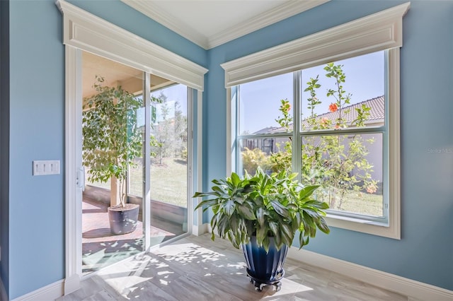 interior space with ornamental molding and baseboards