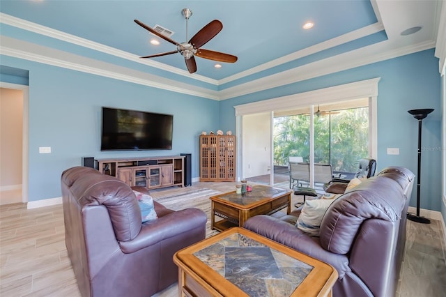 living room featuring light wood finished floors, ornamental molding, visible vents, and baseboards