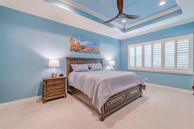 bedroom featuring ornamental molding, a tray ceiling, carpet flooring, and baseboards