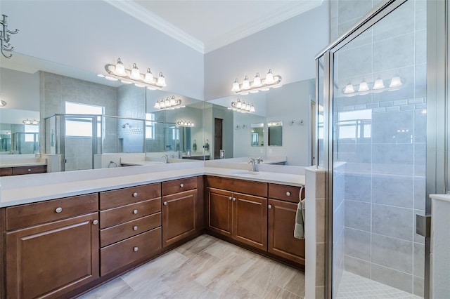 full bath featuring ornamental molding, a sink, a shower stall, and double vanity