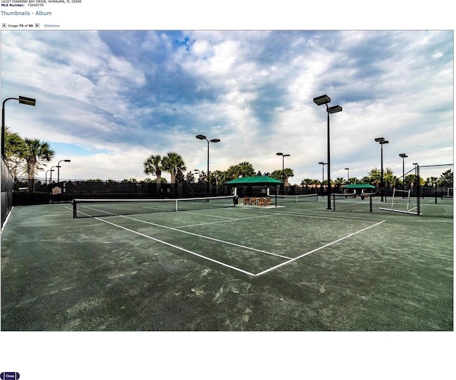 view of sport court featuring fence