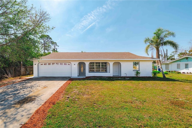 ranch-style house featuring a garage and a front lawn