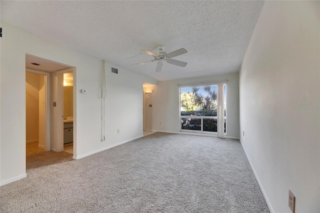 unfurnished room featuring ceiling fan, carpet flooring, and a textured ceiling