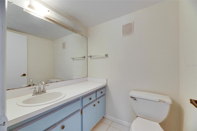 bathroom with vanity, tile patterned floors, and toilet