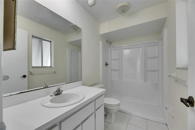 bathroom with vanity, toilet, tile patterned flooring, and a shower