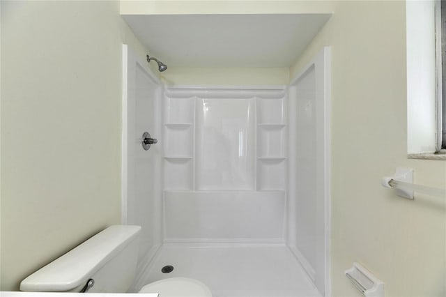 bathroom with toilet and walk in shower