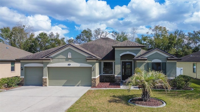 view of front of house with a garage and a front lawn