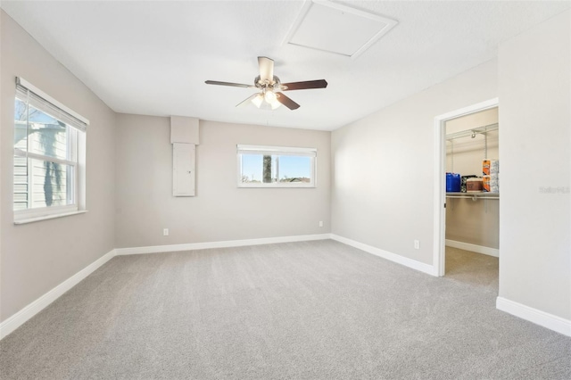 unfurnished room with a healthy amount of sunlight, ceiling fan, and carpet floors