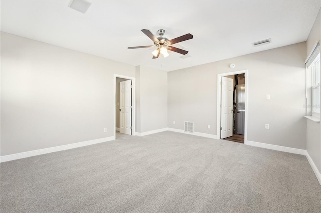 carpeted spare room featuring ceiling fan