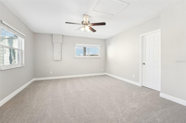 empty room with ceiling fan, carpet flooring, and a wealth of natural light