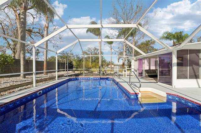 view of swimming pool with a sunroom and glass enclosure