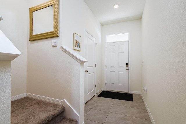 foyer entrance featuring light tile patterned flooring