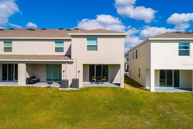 back of property with cooling unit, a lawn, and a patio