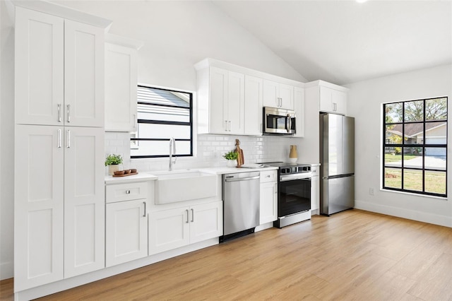 kitchen featuring white cabinetry, stainless steel appliances, and sink