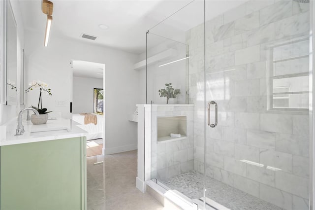 bathroom with tile patterned flooring, an enclosed shower, and vanity