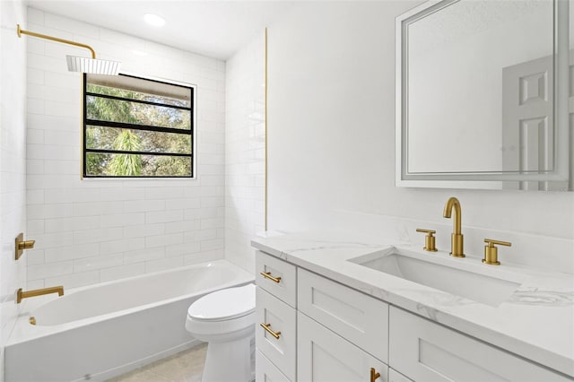 full bathroom with tiled shower / bath, vanity, toilet, and tile patterned flooring