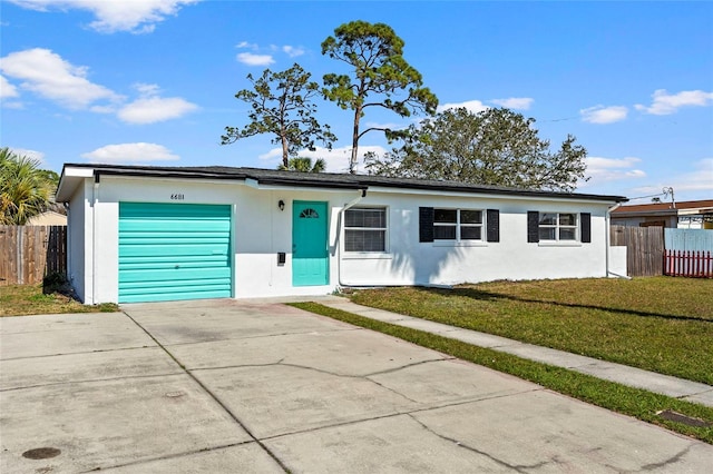 ranch-style home with a garage and a front lawn