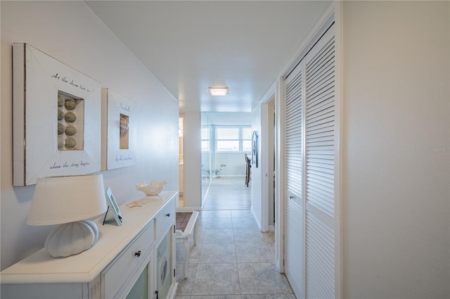 hall with light tile patterned floors