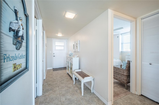 hallway featuring light tile patterned flooring