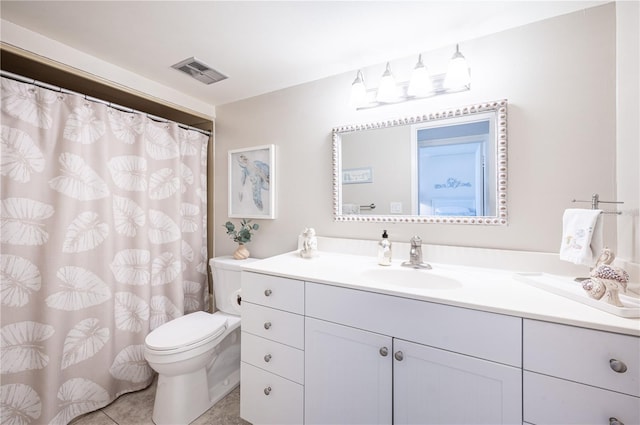 bathroom featuring tile patterned flooring, vanity, and toilet