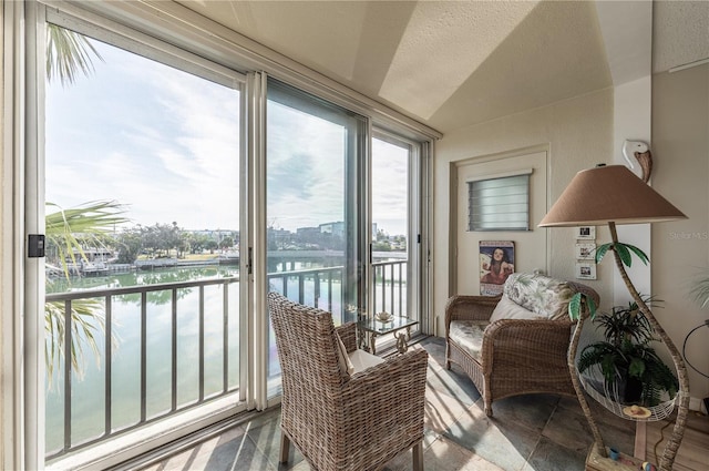 sunroom / solarium featuring a water view