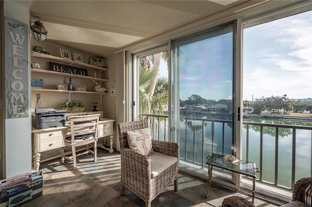 sunroom / solarium with a water view