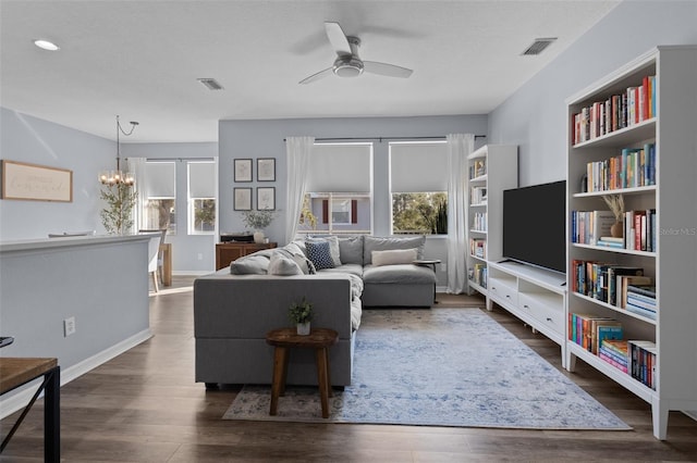 living room featuring ceiling fan with notable chandelier, a textured ceiling, and dark hardwood / wood-style flooring