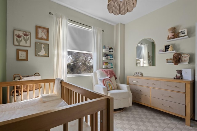 bedroom featuring a crib