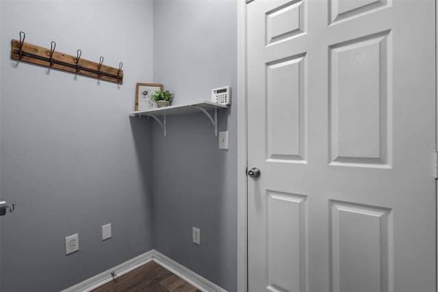 clothes washing area with wood-type flooring