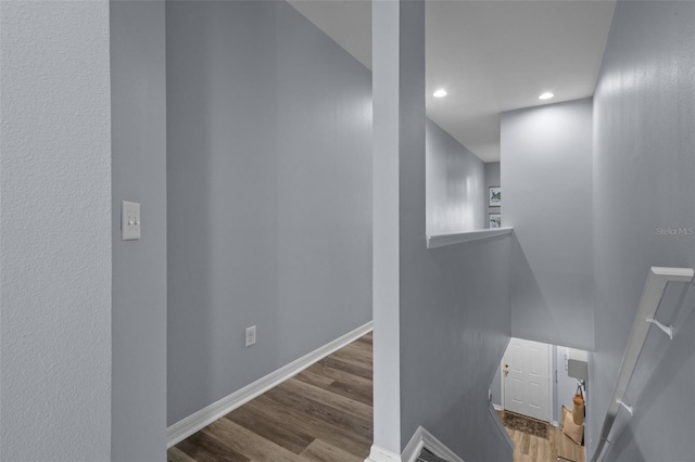 staircase with hardwood / wood-style flooring