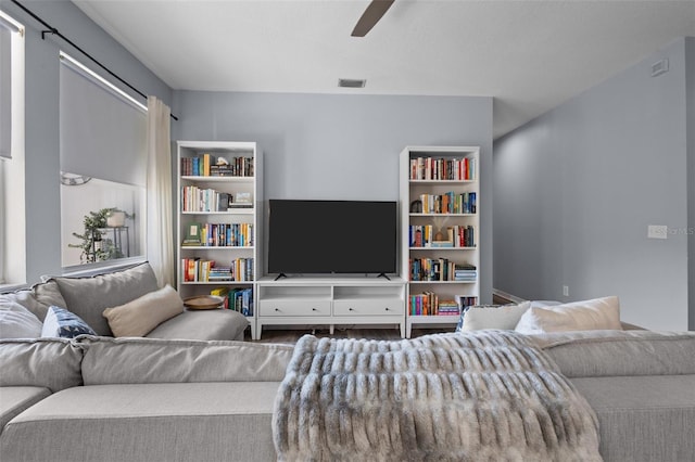 living room with hardwood / wood-style flooring and ceiling fan