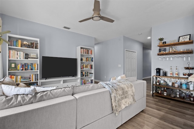 living room with wood-type flooring and ceiling fan