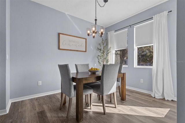 dining room featuring hardwood / wood-style flooring and a notable chandelier