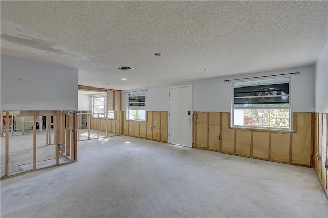 spare room with a textured ceiling