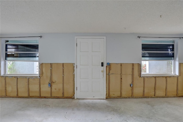 empty room featuring plenty of natural light and a textured ceiling