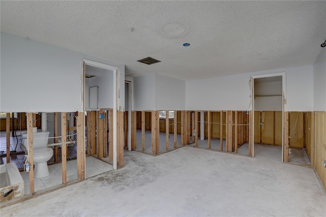 miscellaneous room featuring a textured ceiling