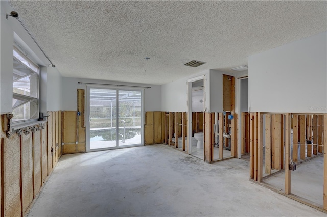 unfurnished room featuring a textured ceiling