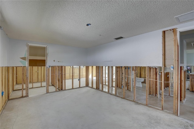 unfurnished room featuring a textured ceiling