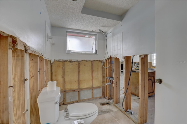 bathroom featuring vanity, a textured ceiling, and toilet