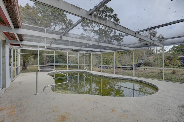 view of swimming pool with a lanai and a patio area