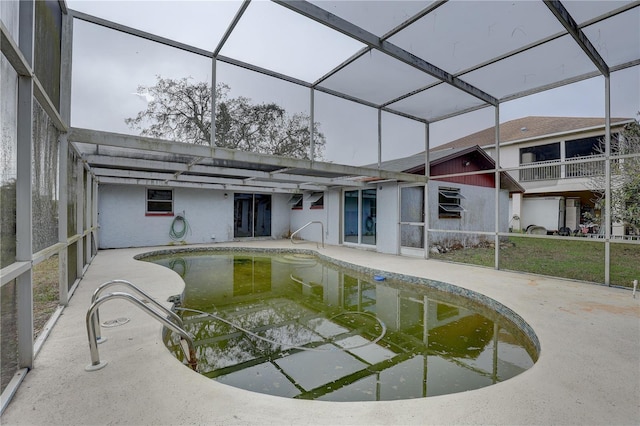 view of pool featuring a patio area and glass enclosure