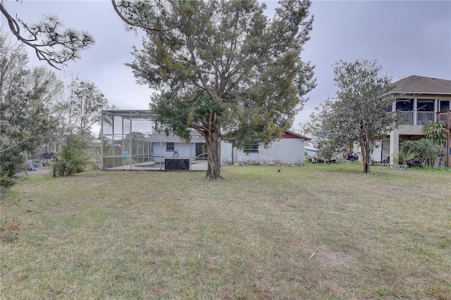 view of yard with glass enclosure