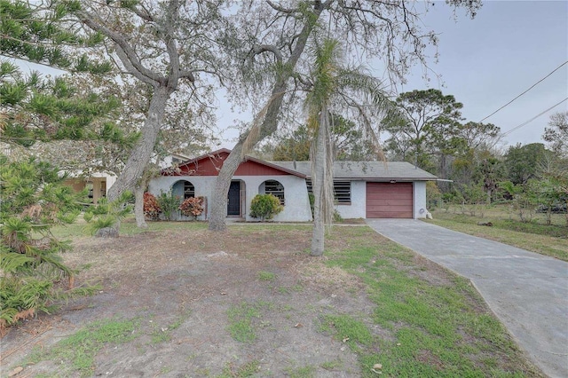 view of front of house with concrete driveway and an attached garage