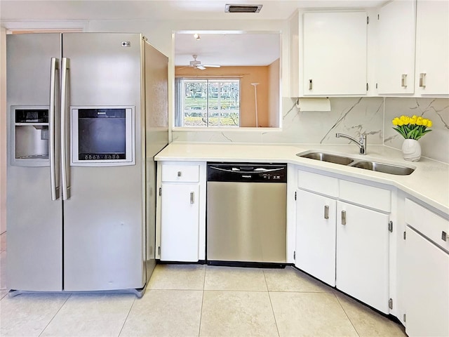 kitchen with visible vents, light countertops, decorative backsplash, stainless steel appliances, and a sink